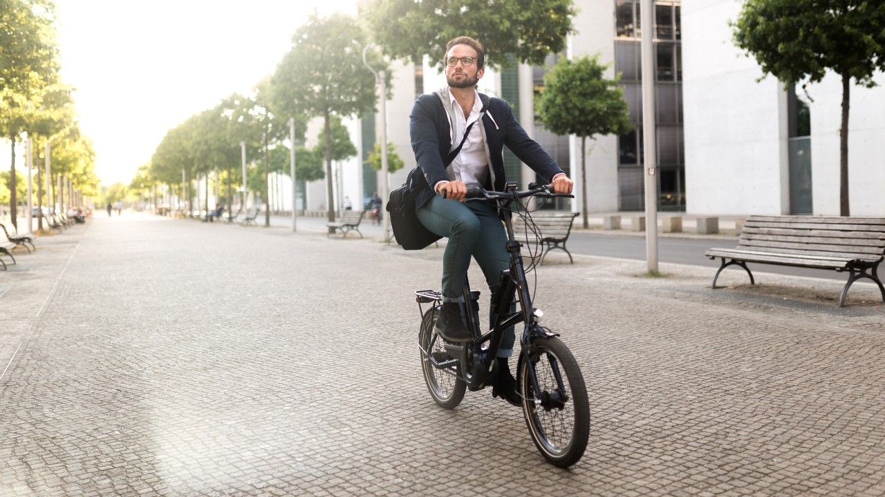 A man in suit on a bike; image used for HSBC India Getting financially fit article