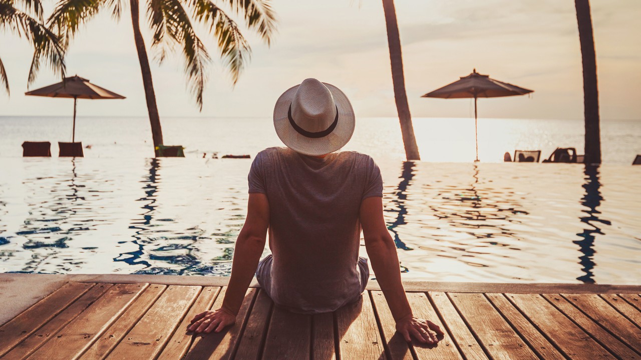 A tourist enjoying sunset at a resort; image used for HSBC India How to stay financial healthy article
