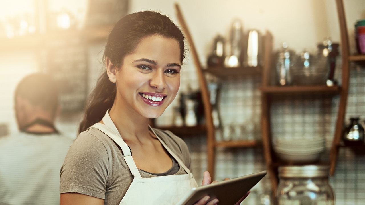 A barista is smiling; image used for HSBC Loan Against Property page.