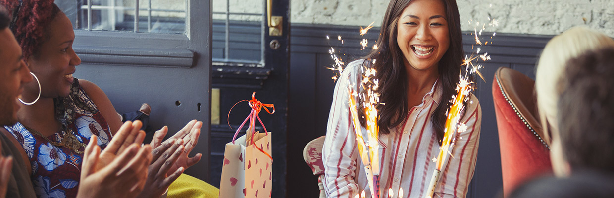 A woman laugh happily in a celebration event; image used for HSBC India Fixed Deposits page