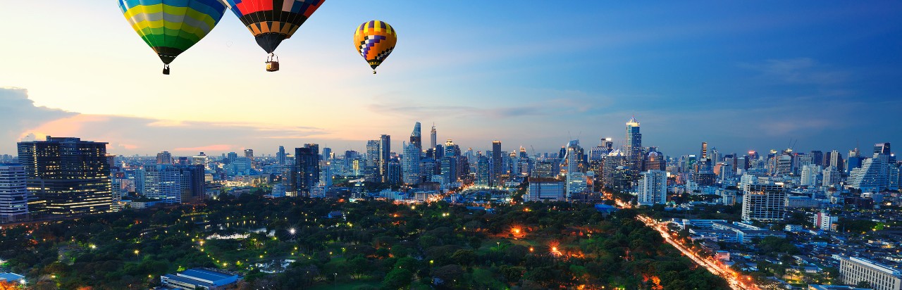 Hot air balloons flying over the city