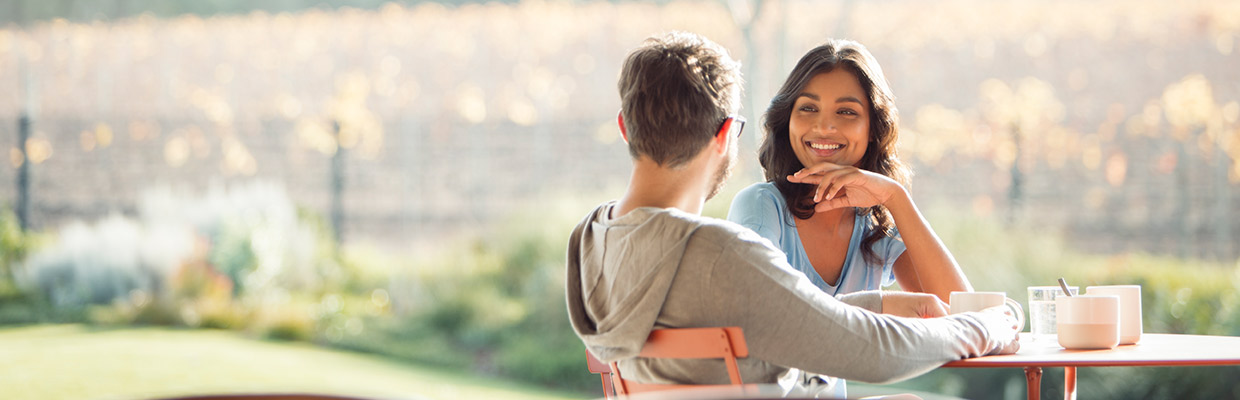 A couple sitting outdoors; image used for HSBC Non-Resident Indian services page.