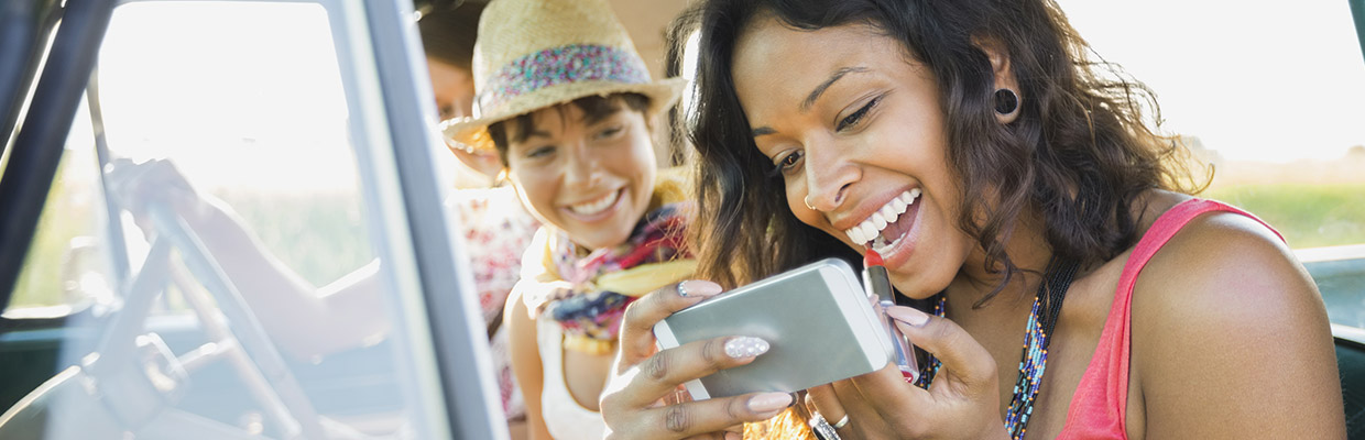 Woman putting on lipstick; image used for HSBC insure smart page.