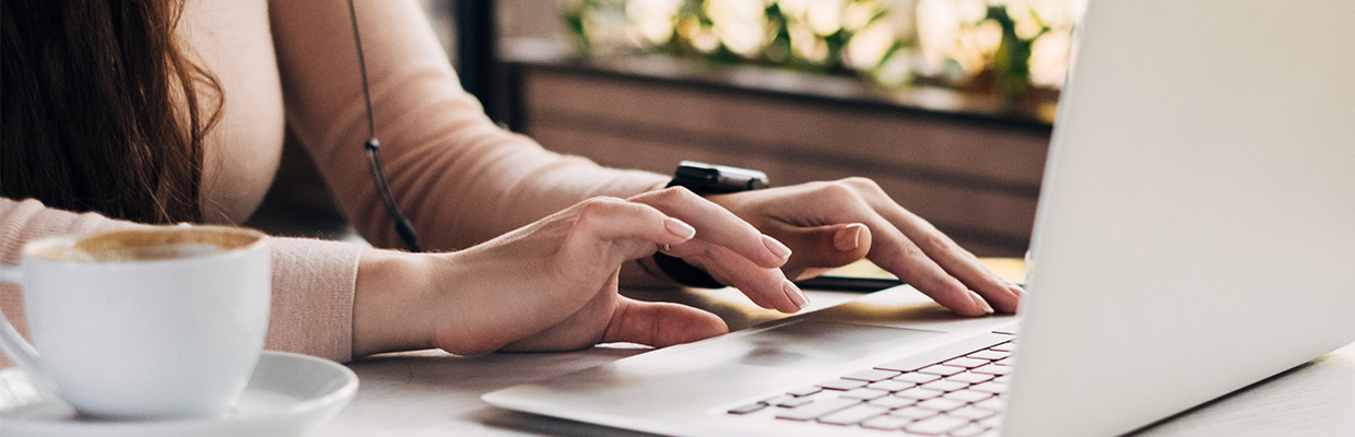 A woman typing on her laptop, image used for HSBC Online Banking page.