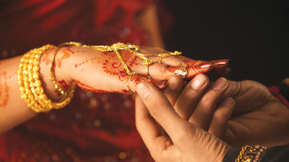Bridegroom is holding bride's hand; image used for HSBC Goal planning page.