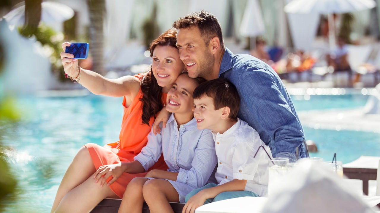 A family is taking a selfie; image used for HSBC Premier Mastercard Credit Card.