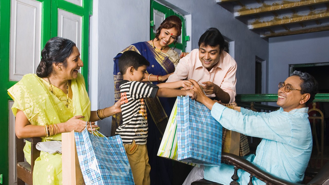 A family holding bags; image used for HSBC Inward Remittance page.