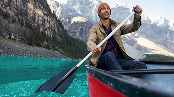 A man is rowing a boat; Image used for Visa Platinum Card page. 