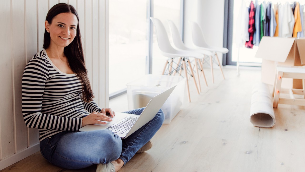 A woman using laptop at home; image used for HSBC FX retail platform