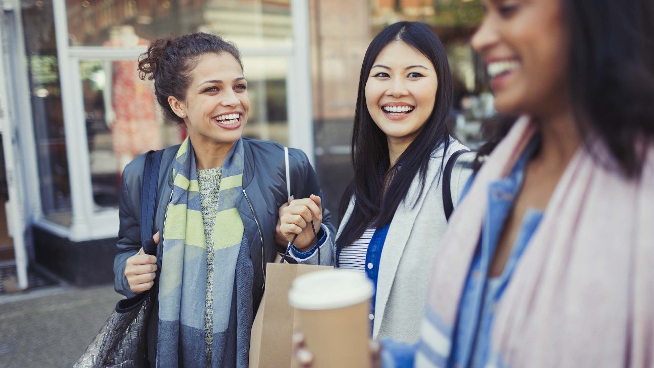 Three women are laughing together; image used for HSBC Credit Card Rewards Catalogue.