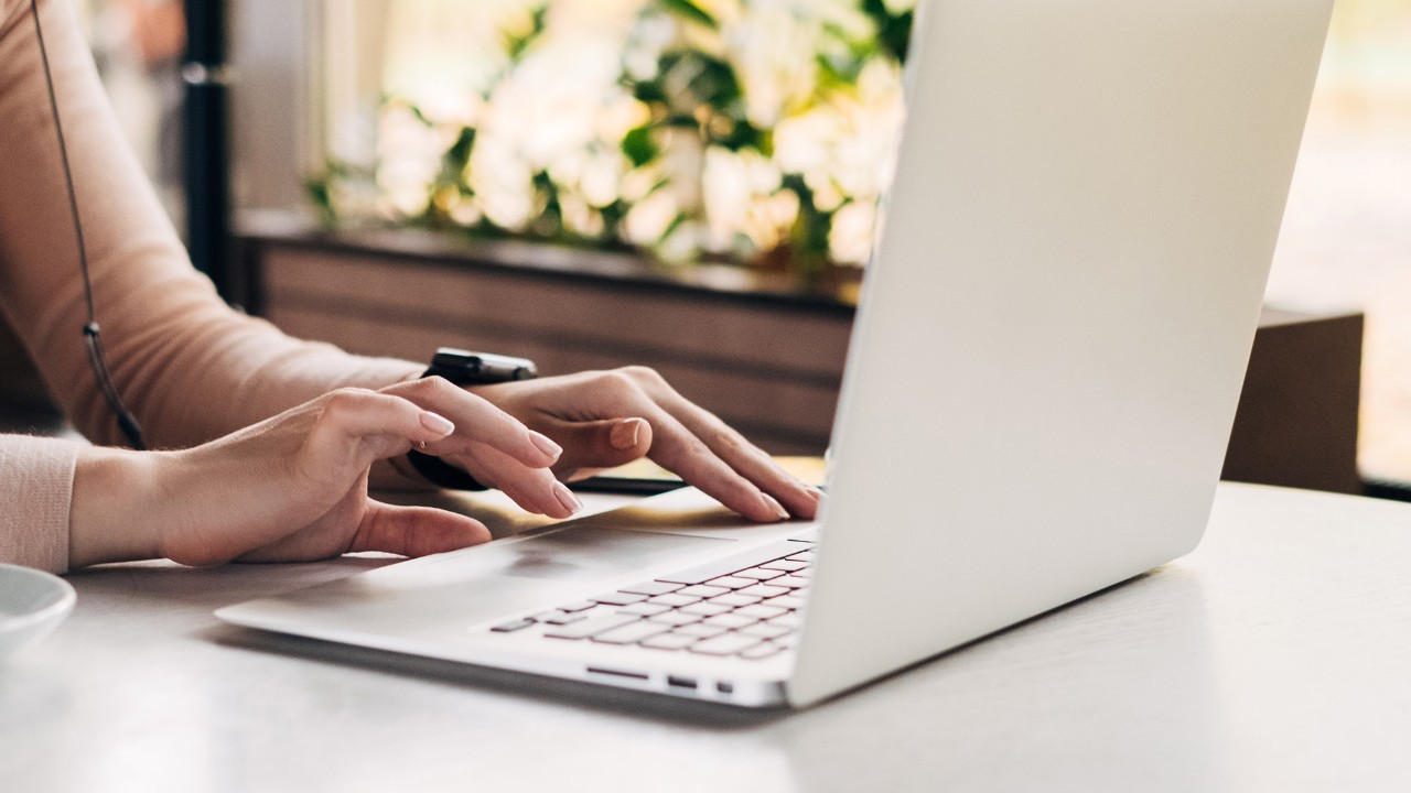 A woman typing on her laptop, image used for HSBC Online Banking page.