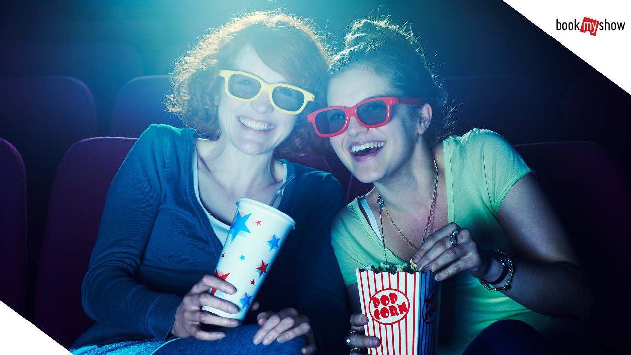 Two women watching a 3D movie at the cinema; image used for HSBC India BookMyShow offer page