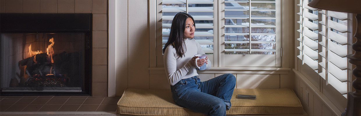 A woman is drinking and relax at home; image used for HSBC Visa Cashback Credit Card
