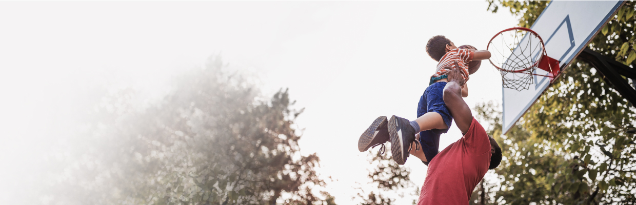 Father playing basketball with child; image used for HSBC Goal planning page.