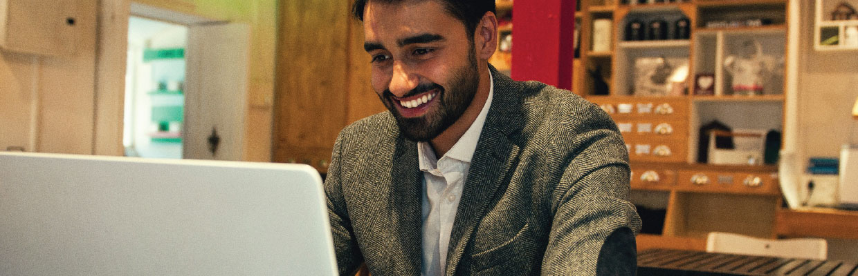 A man looking at computer; image used for HSBC India remittances page.