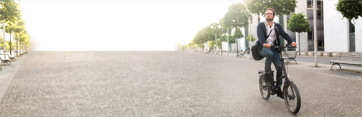 A man in suit on a bike; image used for HSBC India Getting financially fit article