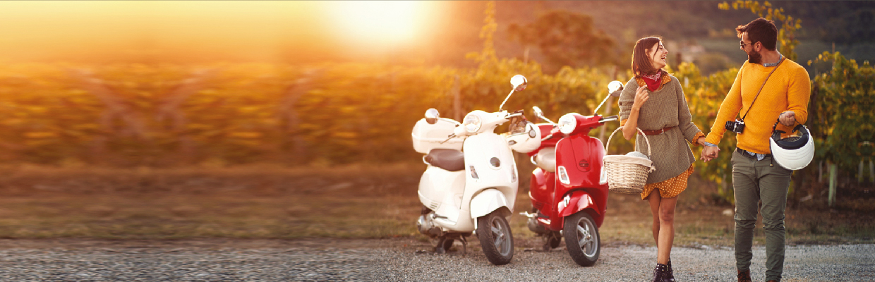 A couple holding hands in front of two bikes; image used for HSBC India Health First Plan page.