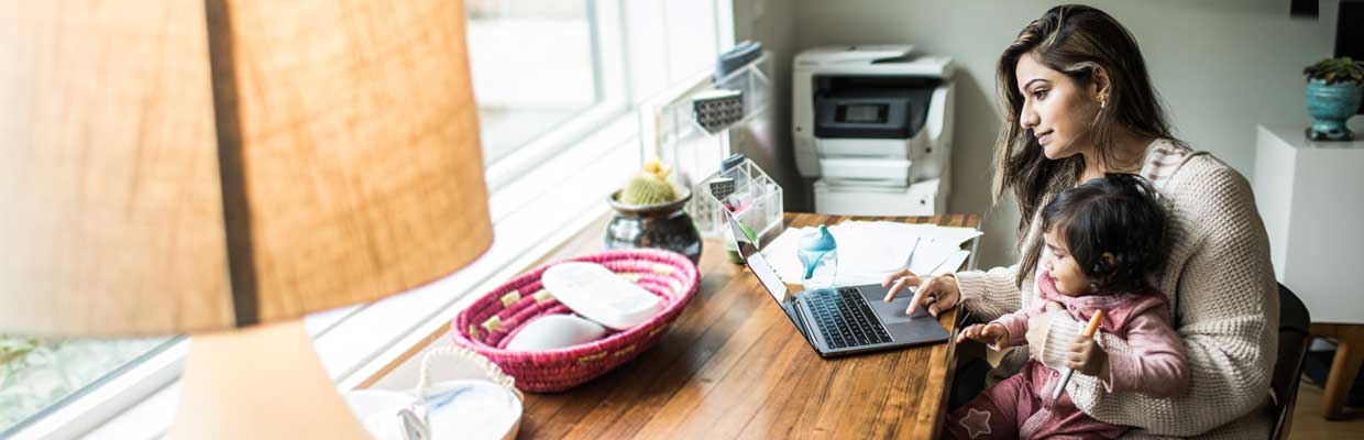 Mother multi-tasking with infant daughter in the living room; image used for HSBC Smart Home Loan page