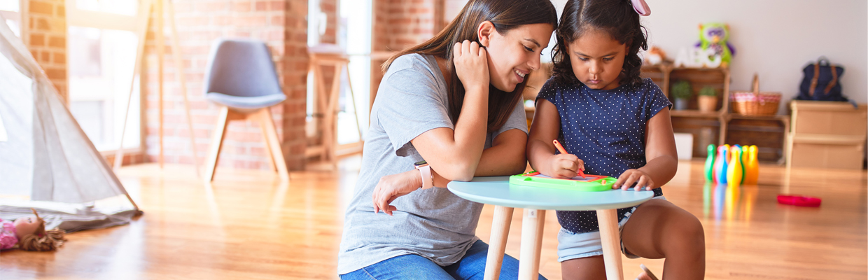 A woman and a little girl drawing in a room; image used for HSBC iSelect Star Term Plan life insurance