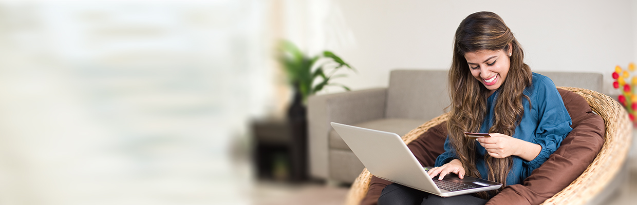 A woman is using her laptop; image used for HSBC India Cashback Credit Card article page.