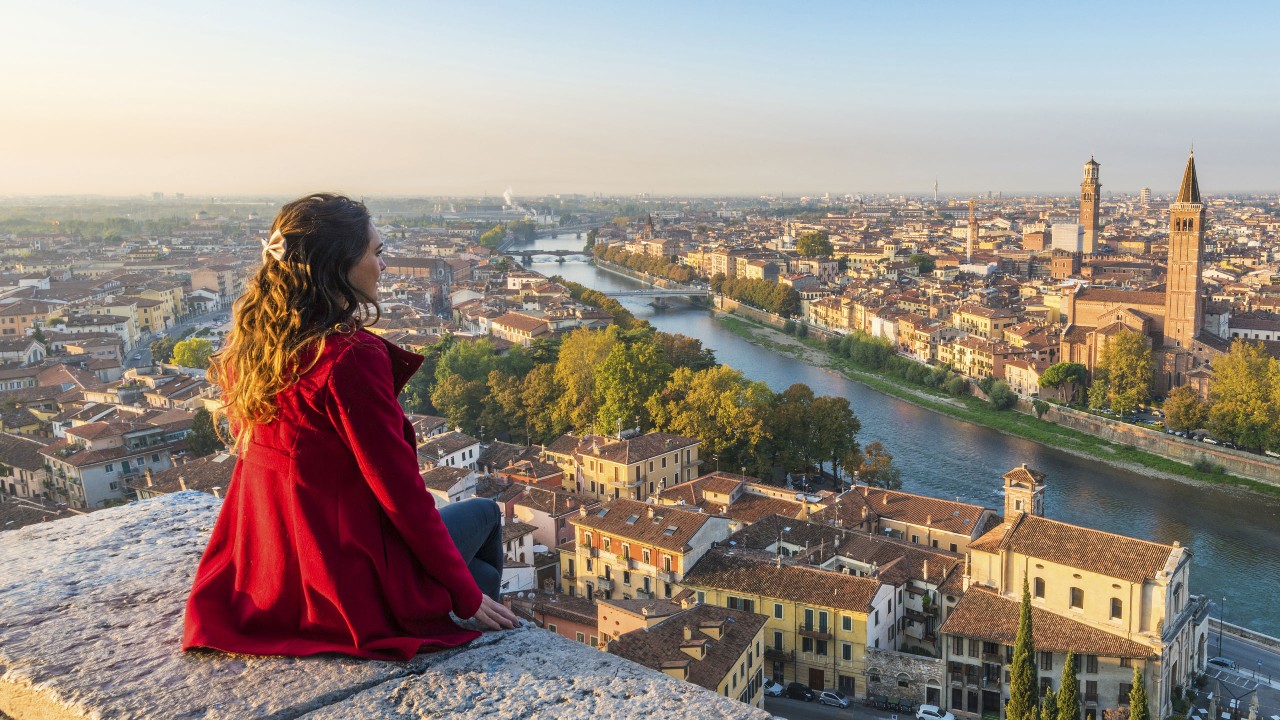 A tourist enjoying view of Verona town; image used for HSBC India NRI Savings account