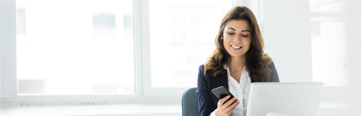 A woman is using mobile and destop; image used for HSBC India Digital Secure Key page