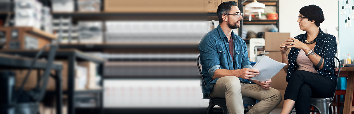 A man and a woman discussing in a work place; image used for HSBC India Investment page